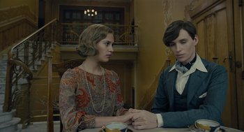 Movie still from “The Danish Girl” (2015), directed by Tom Hooper – A man and a woman sitting at a table holding hands; Medium shot, Over the shoulder angle