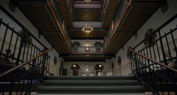 Movie still from “The Danish Girl” (2015), directed by Tom Hooper – A group of people standing on top of a set of stairs; Extreme Wide shot, Low angle