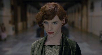 Movie still from “The Danish Girl” (2015), directed by Tom Hooper – A woman with red hair wearing a green dress; Close Up shot, Over the shoulder angle