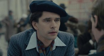 Movie still from “The Danish Girl” (2015), directed by Tom Hooper – A man wearing a hat and a jacket; Close Up shot, Over the shoulder angle