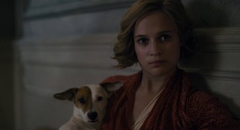 Movie still from “The Danish Girl” (2015), directed by Tom Hooper – A woman and a dog are looking at the camera; Close Up shot, High angle