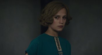Movie still from “The Danish Girl” (2015), directed by Tom Hooper – A young woman in a blue shirt is looking at the camera; Close Up shot, High angle