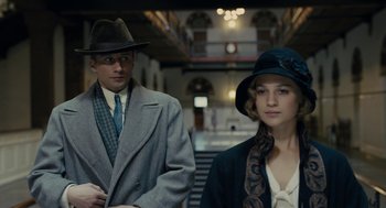 Movie still from “The Danish Girl” (2015), directed by Tom Hooper – A man and a woman standing next to each other; Medium shot, Low angle