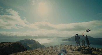 Movie still from “The Danish Girl” (2015), directed by Tom Hooper – A man standing on top of a hill looking at a body of water; Extreme Wide shot, Low angle