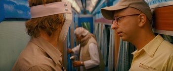 Movie still from “The Darjeeling Limited” (2007), directed by Wes Anderson – Two people in a train with masks on; Close Up shot, Over the shoulder angle