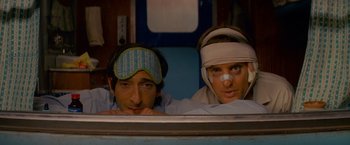 Movie still from “The Darjeeling Limited” (2007), directed by Wes Anderson – A man and a woman with bandages on their heads; Close Up shot, Low angle