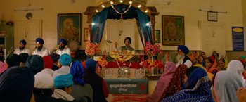 Movie still from “The Darjeeling Limited” (2007), directed by Wes Anderson – A person is standing in front of a mirror; Wide shot, High angle