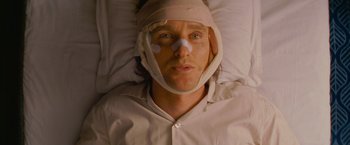 Movie still from “The Darjeeling Limited” (2007), directed by Wes Anderson – A man with a bandage on his head laying in a bed; Close Up shot, High angle
