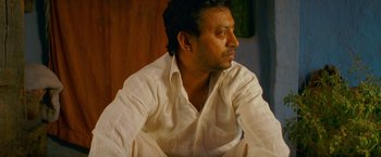 Movie still from “The Darjeeling Limited” (2007), directed by Wes Anderson – A person wearing a white shirt; Close Up shot, Low angle