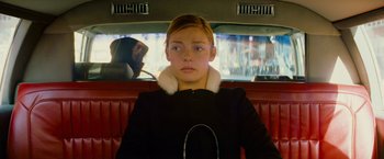 Movie still from “The Darjeeling Limited” (2007), directed by Wes Anderson – A woman sitting in the back seat of a car; Medium shot, Low angle