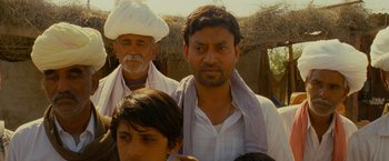 Movie still from “The Darjeeling Limited” (2007), directed by Wes Anderson – A group of men standing next to each other; Close Up shot, Low angle