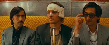 Movie still from “The Darjeeling Limited” (2007), directed by Wes Anderson – A man with a bandage on his head; Close Up shot, Low angle