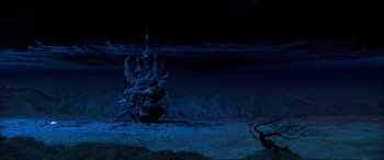 Movie still from “The Dark Crystal” (1982), directed by Frank Oz – A dark picture of a castle in the middle of the night; Extreme Wide shot, High angle