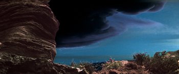Movie still from “The Dark Crystal” (1982), directed by Frank Oz – A dark sky with a dark cloud in the background; Extreme Wide shot, Low angle