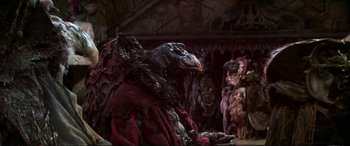 Movie still from “The Dark Crystal” (1982), directed by Frank Oz – A creature in a dark room; Medium shot, Low angle