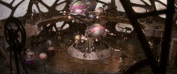 Movie still from “The Dark Crystal” (1982), directed by Frank Oz – An image of a large space station with a lot of planets in it; Extreme Wide shot, High angle