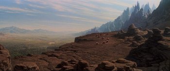 Movie still from “The Dark Crystal” (1982), directed by Frank Oz – A group of animals that are sitting on a hill; Extreme Wide shot, High angle