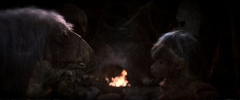 Movie still from “The Dark Crystal” (1982), directed by Frank Oz – A woman and a bird in front of a fire pit; Close Up shot, Over the shoulder angle