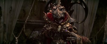 Movie still from “The Dark Crystal” (1982), directed by Frank Oz – A creature with a lot of teeth; Close Up shot, Low angle
