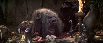 Movie still from “The Dark Crystal” (1982), directed by Frank Oz – An image of a demonic creature; Medium shot, High angle