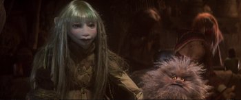Movie still from “The Dark Crystal” (1982), directed by Frank Oz – A woman with long green hair and a green mask; Close Up shot, Low angle