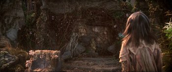 Movie still from “The Dark Crystal” (1982), directed by Frank Oz – A stone wall with flowers growing on it; Wide shot, Low angle