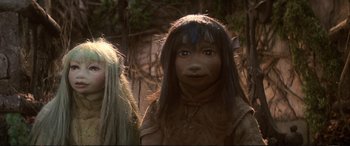 Movie still from “The Dark Crystal” (1982), directed by Frank Oz – A woman with long black hair standing next to another woman with long black hair; Close Up shot, Low angle