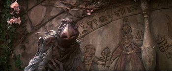 Movie still from “The Dark Crystal” (1982), directed by Frank Oz – A bird's face in front of a wall; Close Up shot, Low angle