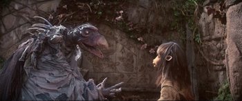 Movie still from “The Dark Crystal” (1982), directed by Frank Oz – An image of a girl and a bird; Medium shot, High angle