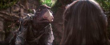 Movie still from “The Dark Crystal” (1982), directed by Frank Oz – An animal that is looking at a woman; Close Up shot, Over the shoulder angle