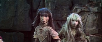Movie still from “The Dark Crystal” (1982), directed by Frank Oz – A woman with a long , black hair standing next to another woman with long , black hair; Close Up shot, Low angle