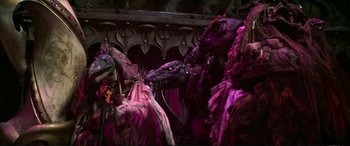 Movie still from “The Dark Crystal” (1982), directed by Frank Oz – A group of people dressed up in purple costumes; Wide shot, High angle