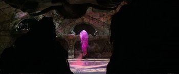 Movie still from “The Dark Crystal” (1982), directed by Frank Oz – A large purple crystal in the middle of a cave; Extreme Wide shot, High angle