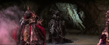Movie still from “The Dark Crystal” (1982), directed by Frank Oz – A couple of people dressed up in costumes; Wide shot, Low angle