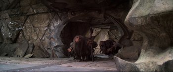 Movie still from “The Dark Crystal” (1982), directed by Frank Oz – A couple of people that are in a cave; Wide shot, Low angle