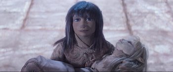 Movie still from “The Dark Crystal” (1982), directed by Frank Oz – A doll with blue eyes and long black hair; Close Up shot, High angle