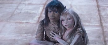 Movie still from “The Dark Crystal” (1982), directed by Frank Oz – A couple of people that are sitting next to each other; Close Up shot, High angle