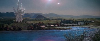 Movie still from “The Dark Crystal” (1982), directed by Frank Oz – A view of a river and mountains in the distance; Extreme Wide shot, High angle