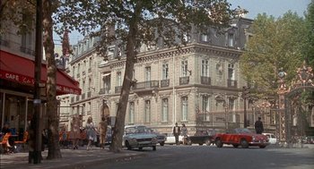 Movie still from “The Day of the Jackal” (1973), directed by Fred Zinnemann – A group of people standing on the side of a road; Extreme Wide shot, High angle