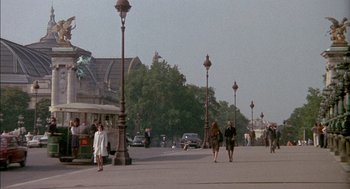 Movie still from “The Day of the Jackal” (1973), directed by Fred Zinnemann – People are walking down the street on a sunny day; Extreme Wide shot, Low angle