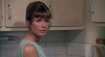 Movie still from “The Day of the Jackal” (1973), directed by Fred Zinnemann – A person in a kitchen area; Close Up shot, Over the shoulder angle