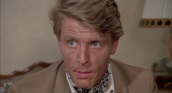 Movie still from “The Day of the Jackal” (1973), directed by Fred Zinnemann – A person wearing a suit and tie; Close Up shot, Low angle