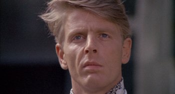 Movie still from “The Day of the Jackal” (1973), directed by Fred Zinnemann – A person wearing a dress shirt; Close Up shot, Low angle
