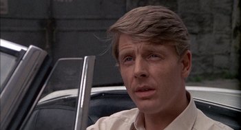 Movie still from “The Day of the Jackal” (1973), directed by Fred Zinnemann – A person wearing a white shirt; Close Up shot, Over the shoulder angle