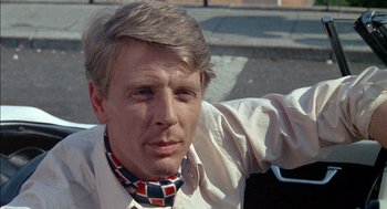 Movie still from “The Day of the Jackal” (1973), directed by Fred Zinnemann – A person wearing a neck tie; Close Up shot, Low angle