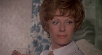 Movie still from “The Day of the Jackal” (1973), directed by Fred Zinnemann – A person wearing a tie and holding a glass; Close Up shot, Low angle