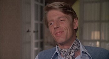 Movie still from “The Day of the Jackal” (1973), directed by Fred Zinnemann – A person wearing a neck scarf; Close Up shot, Low angle