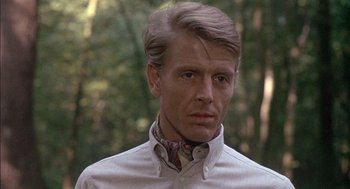 Movie still from “The Day of the Jackal” (1973), directed by Fred Zinnemann – A person wearing a dress shirt; Close Up shot, Low angle