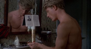 Movie still from “The Day of the Jackal” (1973), directed by Fred Zinnemann – A man looking in the mirror in front of a bathroom mirror; Close Up shot, Over the shoulder angle