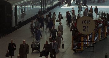 Movie still from “The Day of the Jackal” (1973), directed by Fred Zinnemann – A crowd of people walking down a street; Extreme Wide shot, High angle